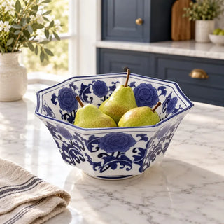 Blue and white centerpiece bowl with pears on marble kitchen benchtop by navy cabinets