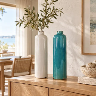 Blue and white ceramic vase both colours with olive branches on oak sideboard