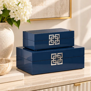 Blue decorative boxes set of 2 stacked on marble sideboard with white hydrangeas