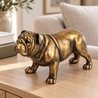 Bronze bulldog figurine on light oak side table beside beige sofa and books