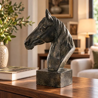Bronze horse head sculpture on walnut console beside hardcover book and speckled vase
