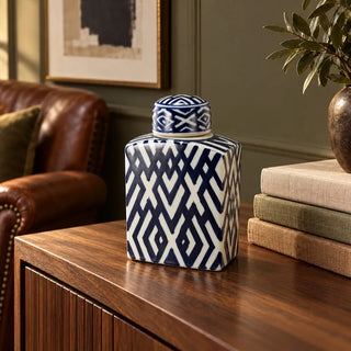Carlyle lidded rectangular jar on fluted wood sideboard beside leather armchair