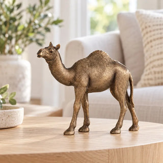 Desert camel ornament on oak coffee table in front of cream sofa