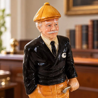 Golfer statue close up of moustached face orange flat cap and black jacket