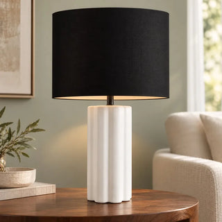 Horizon ceramic lamp on round walnut side table beside cream armchair
