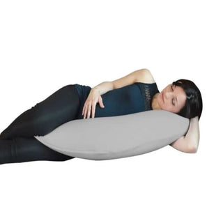 Pregnant woman resting on side with large grey maternity body pillow