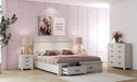 Modern bedroom with white wooden bed and storage, matching nightstands and dresser, pink accents