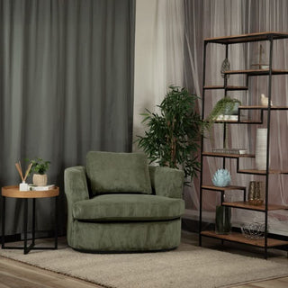 Modern living room with green swivel armchair, wooden side table, shelving unit and indoor plant