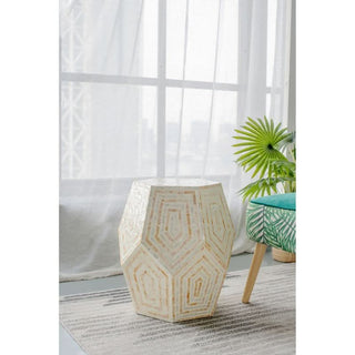 Geometric white mosaic side table in modern living room with green plant and patterned chair