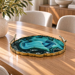Luxe dark marble decorative tray on stone coffee table with olive branches