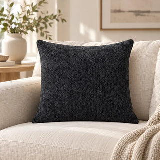 60cm x 60cm Midnight rain cushion charcoal square on cream sofa beside vase of leafy branches