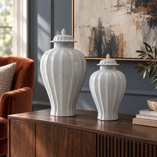 New port white jar 40cm and 61cm on walnut sideboard beside rust velvet armchair