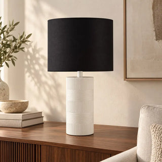 Norman ceramic lamp on fluted walnut sideboard beside books and speckled bowl