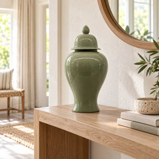 Oasis teal ceramic jar on oak console table below round wooden mirror