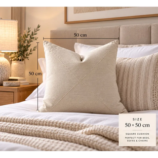 Oatmeal textured cushion size guide on bed with knit throw