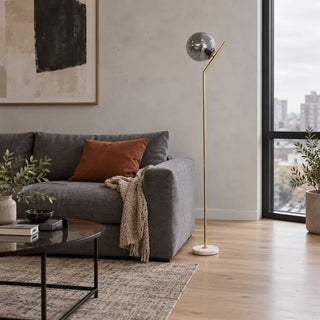Parisian poise floor lamp with marble base beside grey sofa and city view window