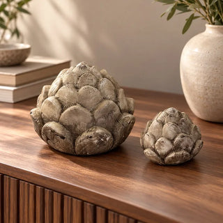 Pine cone flower decor large and small on walnut sideboard beside speckled ceramic vase