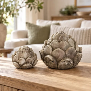 Pine cone flower decor small and large on oak coffee table in front of cream sofa