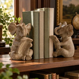 Reading elephant bookend set on dark timber shelf with green and oatmeal linen books