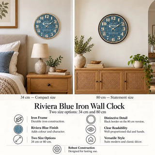 Riviera blue iron wall clock 34cm above oak bedside table and ceramic lamp