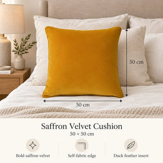 Saffron velvet cushion size guide 50cm x 50cm on bed with cream textured pillows