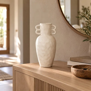 Sandroot wave handle vase on fluted oak sideboard beside round timber mirror