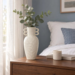 Sandroot wave handle vase with eucalyptus on walnut bedside table beside sheer curtain