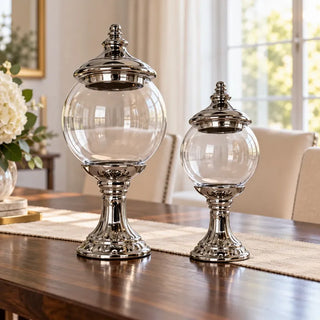 Silver stem glass jar in two sizes on dark timber dining table with linen runner