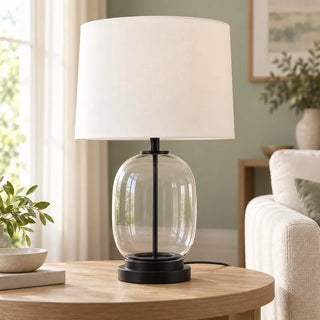Soho glass lamp on round oak side table against sage green wall
