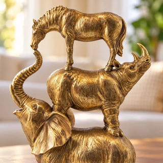 Stacking animals tower statue gold close up of rhino and raised elephant trunk