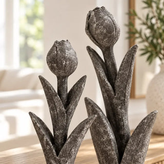 Tulip flower sculpture close up of charcoal grey buds and leaves
