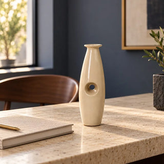 Uno vase on speckled stone desk beside notebook against navy wall