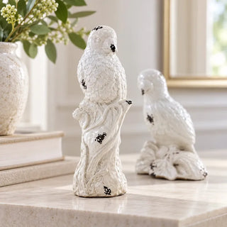 Vintage white ceramic parrot statues branch stump bird on beige marble with vase