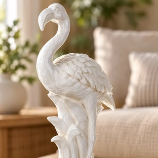 White flamingo ornament close up of curved beak and sculpted wing feathers