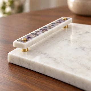 White marble tray with gold handles close up of purple mosaic inlay and polished edge