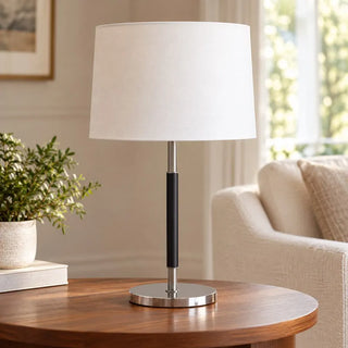 Zagna modern metal table lamp on round timber side table beside cream armchair