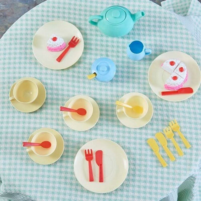 Kids sharing a moment of laughter while serving play cake at their tea party with the Casdon Tea Set